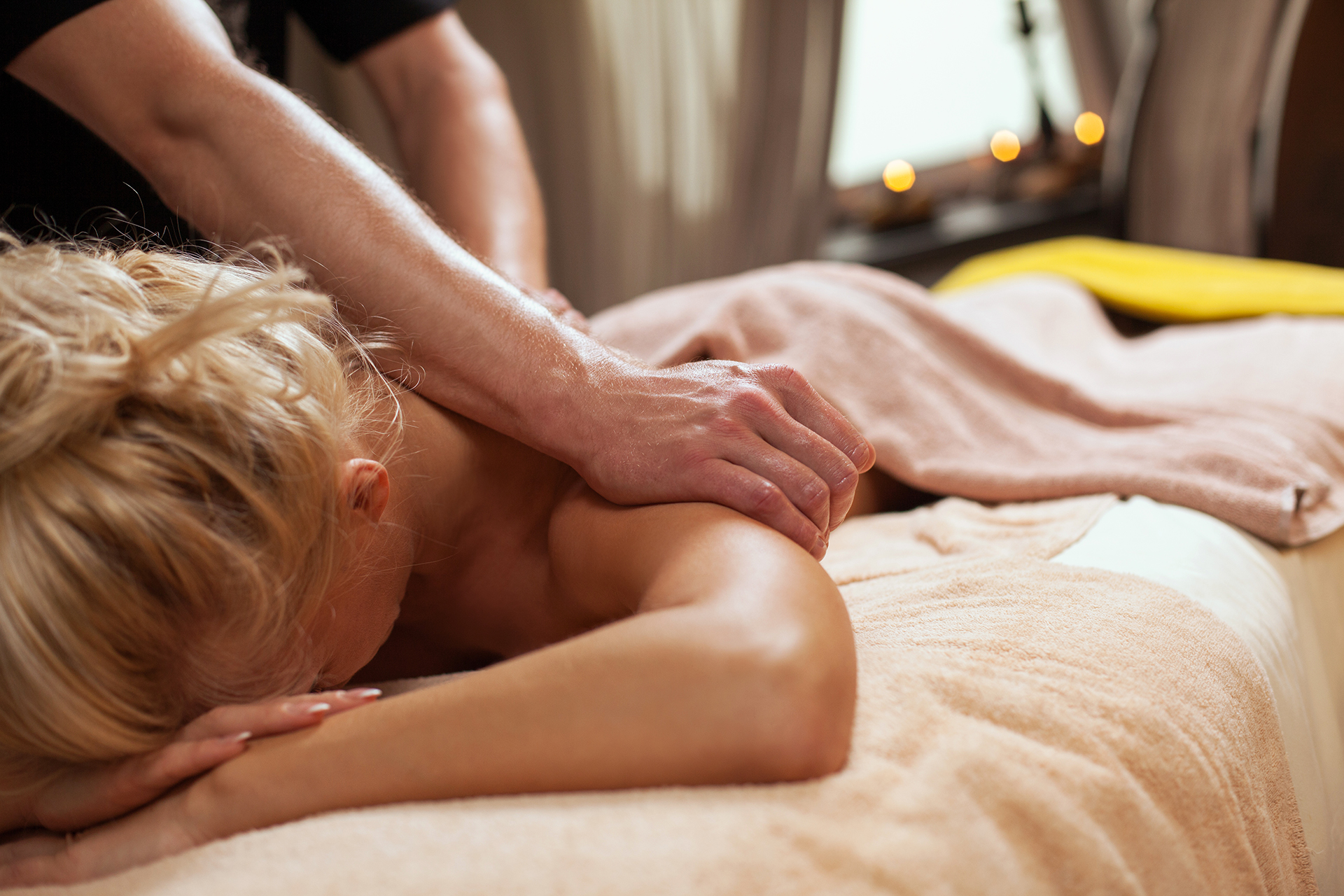 Young woman enjoys massage in a luxury spa