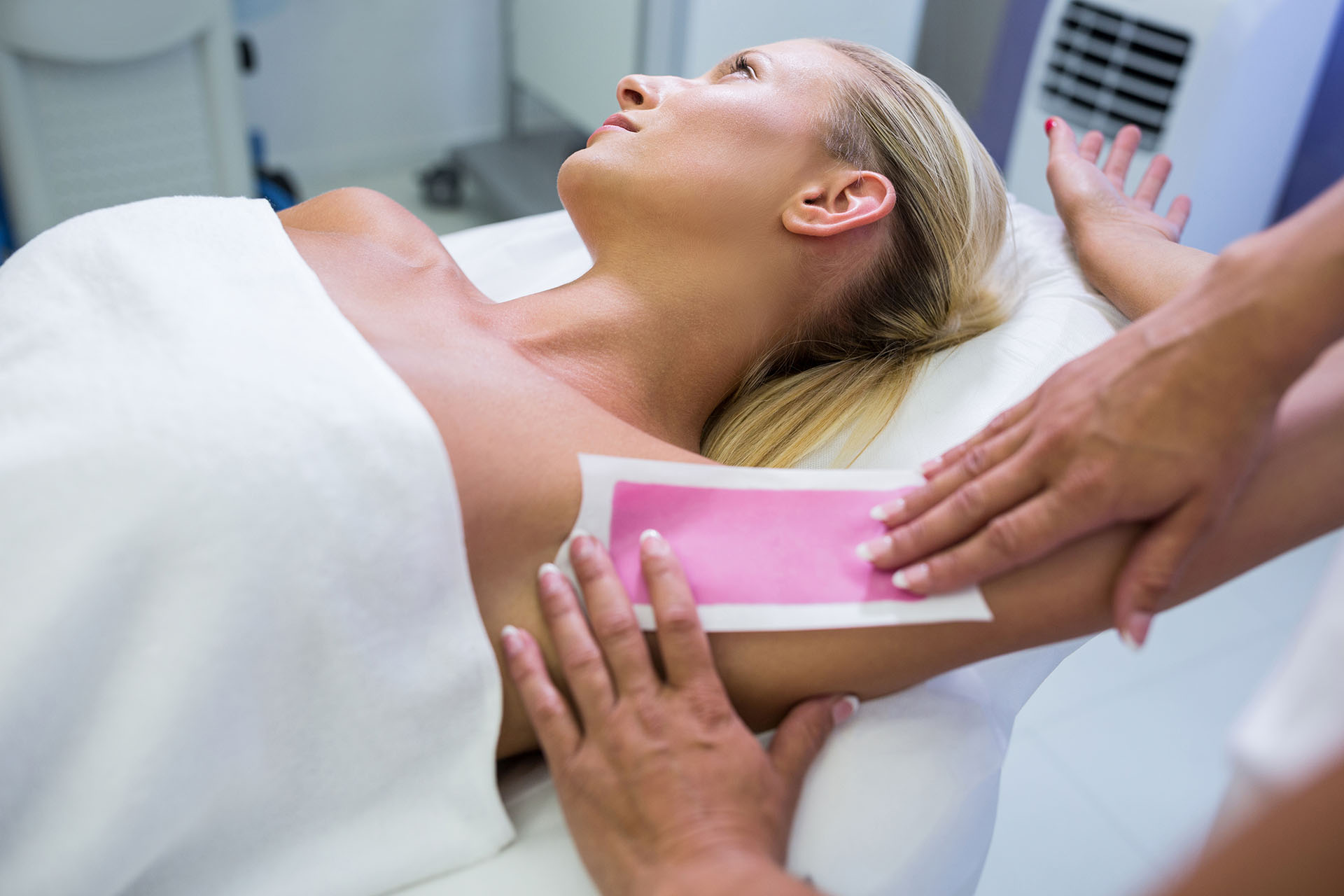 Woman getting her armpit hair removed at beauty salon