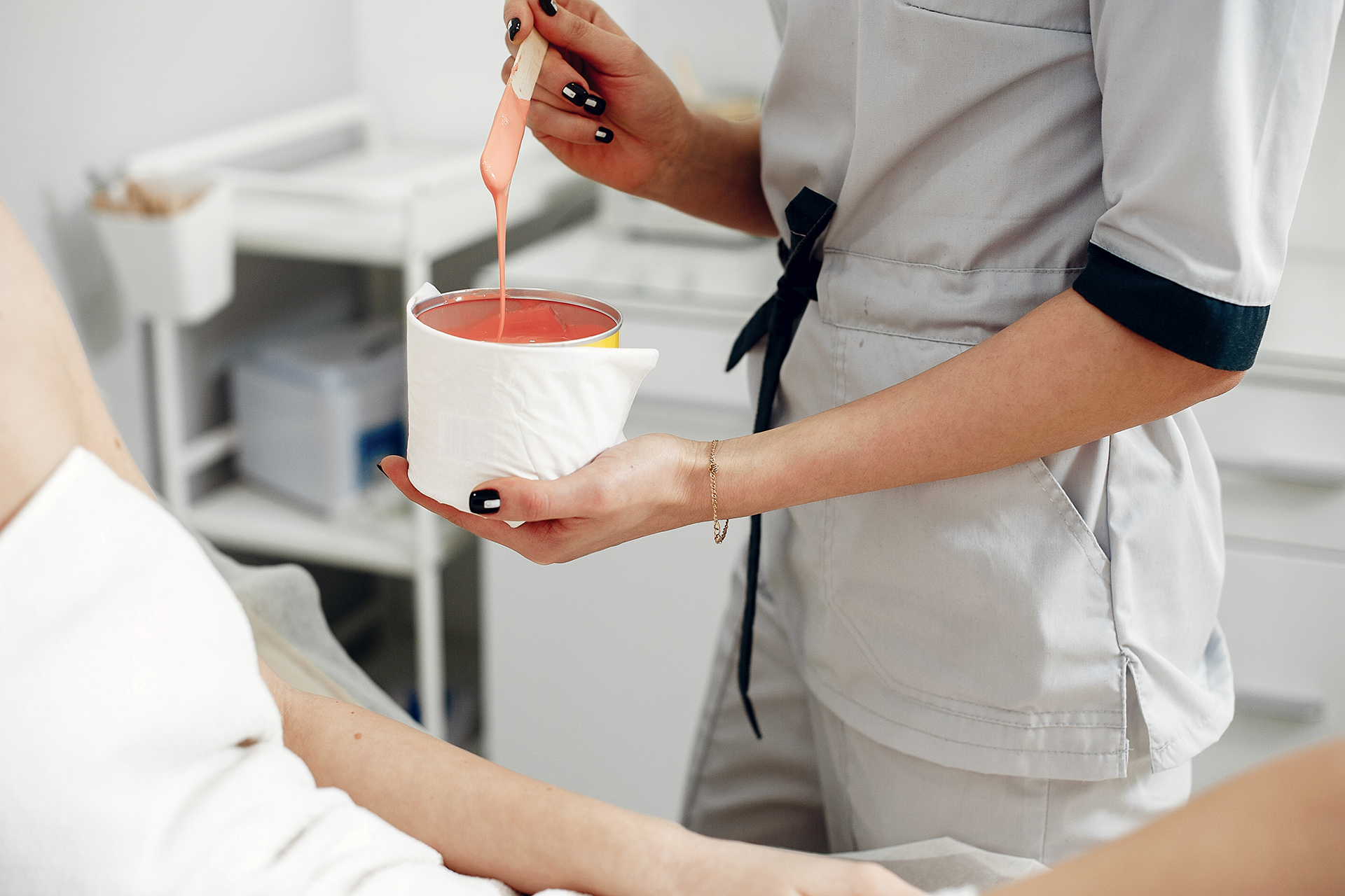 Beautiful girl doing hair removal. Woman in beauty salon